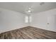 Minimalist bedroom with hardwood floors, a ceiling fan, and bright natural light at 5622 Sage Pines Dr, Las Vegas, NV 89118