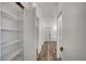 Hallway view featuring an open shelving system and a doorway to the bathroom at 5622 Sage Pines Dr, Las Vegas, NV 89118