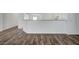 Open concept living area with modern flooring, half wall to kitchen, and neutral paint at 5622 Sage Pines Dr, Las Vegas, NV 89118