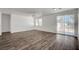 Bright and airy living room with modern flooring, ceiling fan, and access to the backyard at 5622 Sage Pines Dr, Las Vegas, NV 89118
