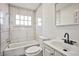 Bathroom featuring tiled shower and floors, and updated fixtures at 603 W Adams Ave, Las Vegas, NV 89106