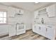 Bright kitchen features white cabinetry, stainless steel appliances, and modern countertops at 603 W Adams Ave, Las Vegas, NV 89106