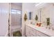 Bright bathroom features double sinks, decorative mirrors, and a shower-tub combo at 6060 N Conquistador St, Las Vegas, NV 89149