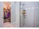 Bathroom featuring a walk-in shower with glass doors, a closet, and tiled flooring at 6060 N Conquistador St, Las Vegas, NV 89149