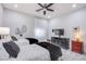 Bright bedroom features two twin beds with decorative pillows and throws, stylish furnishings, and a ceiling fan at 6060 N Conquistador St, Las Vegas, NV 89149