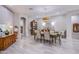 Bright dining room boasts a stunning chandelier, elegant decor, and tile flooring at 6060 N Conquistador St, Las Vegas, NV 89149