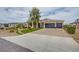 Attractive single-story home with a three-car garage, xeriscaping, and combination driveway at 6060 N Conquistador St, Las Vegas, NV 89149