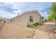 Side exterior featuring low-maintenance desert landscaping and stone pathway at 6060 N Conquistador St, Las Vegas, NV 89149