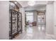 Bright foyer with double entry doors, contemporary chandelier, and marble floors at 6060 N Conquistador St, Las Vegas, NV 89149