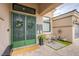 Home entrance with a decorative door, outdoor seating area, and brick-paved walkway at 6060 N Conquistador St, Las Vegas, NV 89149