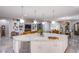 Large kitchen island with quartz countertops and sink at 6060 N Conquistador St, Las Vegas, NV 89149