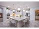 Modern kitchen with quartz counters, a large island, and stainless-steel appliances at 6060 N Conquistador St, Las Vegas, NV 89149