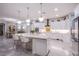 Modern kitchen features marble counters, an island, and stainless-steel appliances at 6060 N Conquistador St, Las Vegas, NV 89149