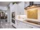 Modern kitchen features stainless steel appliances, white cabinets, and a backsplash with decorative heart design at 6060 N Conquistador St, Las Vegas, NV 89149