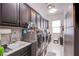 Spacious laundry room featuring modern washer and dryer, ample cabinetry, a utility sink, and lots of storage at 6060 N Conquistador St, Las Vegas, NV 89149