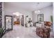 Bright and open living room with contemporary chandelier, marble floors, and an adjoining seating area at 6060 N Conquistador St, Las Vegas, NV 89149