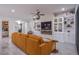 Bright living room boasts custom built-ins, a fireplace, and an expansive view of the home's open layout at 6060 N Conquistador St, Las Vegas, NV 89149