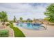 Lush backyard featuring a large, kidney-shaped pool with a slide and spa, surrounded by mature trees and landscaping at 6060 N Conquistador St, Las Vegas, NV 89149