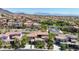 Stunning aerial view of a meticulously planned community with well-maintained homes and lush landscaping at 628 Chervil Valley Dr, Las Vegas, NV 89138