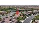 Aerial view of a property featuring a red tile roof, pool, and lush landscaping in a residential area at 628 Chervil Valley Dr, Las Vegas, NV 89138