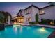 Spacious backyard with a pool, waterfall feature, and a covered patio, creating an outdoor retreat at 628 Chervil Valley Dr, Las Vegas, NV 89138