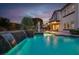 Expansive backyard with a refreshing pool, elegant waterfalls, and a covered patio for relaxation at 628 Chervil Valley Dr, Las Vegas, NV 89138