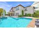 Beautiful backyard with a large pool, covered patio, and well-manicured landscaping at 628 Chervil Valley Dr, Las Vegas, NV 89138