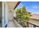 Charming balcony with wrought iron railing offers tranquil views of the home's architecture and mature landscaping at 628 Chervil Valley Dr, Las Vegas, NV 89138