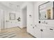 This bright bathroom features double sinks, stone tile flooring, and ample cabinet space at 628 Chervil Valley Dr, Las Vegas, NV 89138