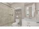 Modern bathroom features tiled walk-in shower, marble vanity, and decorative shelving for a clean, luxurious feel at 628 Chervil Valley Dr, Las Vegas, NV 89138