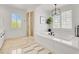 Bright bathroom features a soaking tub, walk-in shower, and abundant natural light from large windows with shutters at 628 Chervil Valley Dr, Las Vegas, NV 89138