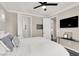 Modern bedroom with a ceiling fan, an accent wall decor, and a mounted TV at 628 Chervil Valley Dr, Las Vegas, NV 89138