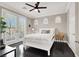 Bright bedroom with large French doors, three arched windows, and a sleek ceiling fan at 628 Chervil Valley Dr, Las Vegas, NV 89138