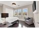 Serene bedroom with hardwood floors, plantation shutters, and an accent chair for a cozy retreat at 628 Chervil Valley Dr, Las Vegas, NV 89138