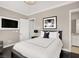 Comfortable bedroom features a queen-sized bed, hardwood floors, and ample natural light from adjacent bathroom at 628 Chervil Valley Dr, Las Vegas, NV 89138