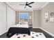 Comfortable bedroom featuring neutral walls, ceiling fan, and a large window at 628 Chervil Valley Dr, Las Vegas, NV 89138