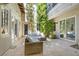 Charming courtyard with trees, potted plants, string lights and wicker furniture for relaxing and entertaining at 628 Chervil Valley Dr, Las Vegas, NV 89138