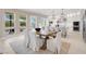 Bright dining area open to a modern kitchen with white cabinets and stainless steel appliances at 628 Chervil Valley Dr, Las Vegas, NV 89138