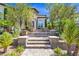 Charming entrance with stone steps, lush landscaping, and a view of the front door at 628 Chervil Valley Dr, Las Vegas, NV 89138