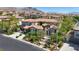 Elegant two-story home with a red tile roof and lush landscaping in a desirable neighborhood at 628 Chervil Valley Dr, Las Vegas, NV 89138