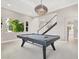Spacious game room with pool table, statement light fixture, and bright natural light at 628 Chervil Valley Dr, Las Vegas, NV 89138