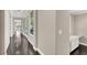 Well-lit hallway with hardwood floors, white trim, and a built-in desk/storage area at 628 Chervil Valley Dr, Las Vegas, NV 89138