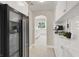 Butler's pantry with white cabinets, marble countertops, and built-in wine fridge leading to the kitchen at 628 Chervil Valley Dr, Las Vegas, NV 89138
