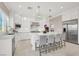 Beautiful modern kitchen with white cabinets, stainless steel appliances, marble countertops, and island seating at 628 Chervil Valley Dr, Las Vegas, NV 89138
