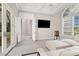 Bright living room featuring a white sectional sofa, large windows, and a modern entertainment center at 628 Chervil Valley Dr, Las Vegas, NV 89138