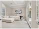 Bright living room with white furniture, a 'Welcome to Las Vegas' sign, and French doors at 628 Chervil Valley Dr, Las Vegas, NV 89138