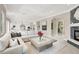 Open-concept living room featuring a stone fireplace, modern kitchen, and comfortable seating at 628 Chervil Valley Dr, Las Vegas, NV 89138