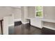 Loft area featuring hardwood floors, a window with shutters, and a built-in desk for work or study at 628 Chervil Valley Dr, Las Vegas, NV 89138