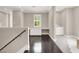 Upstairs loft area featuring hardwood floors, dedicated desk space, and a separate carpeted nook at 628 Chervil Valley Dr, Las Vegas, NV 89138