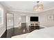 Well-lit main bedroom featuring dark wood floors and a large mirror at 628 Chervil Valley Dr, Las Vegas, NV 89138